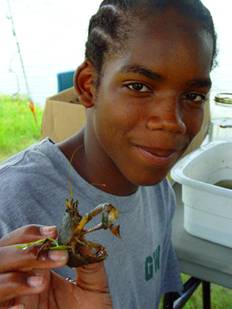 High school student at Gainesville Wilderness Institute with a crawfish collected from local waters.